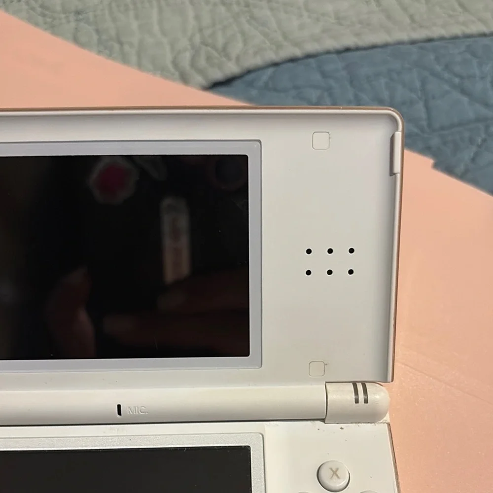 White Handheld Gaming Console with Pink Ribbon